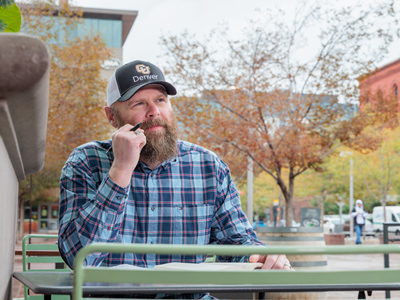 CU Denver business student sitting outside