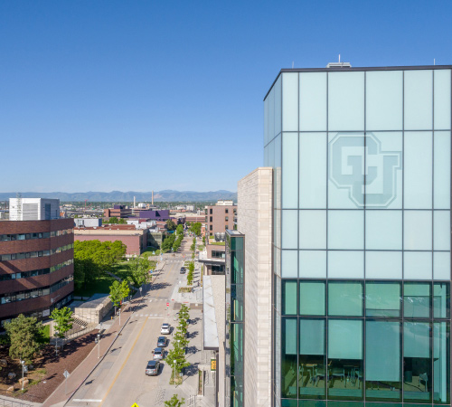 CU Denver building with Rocky Mountains in the distance