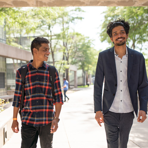 CU Denver students talking while walking around campus