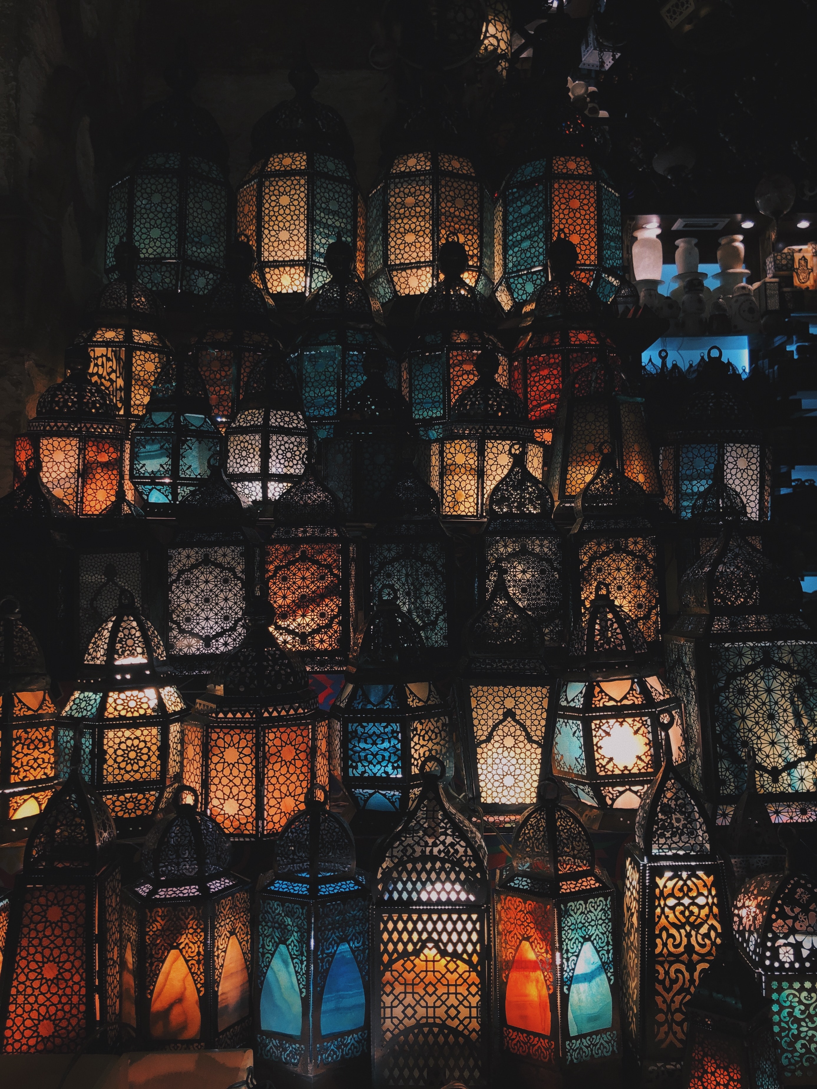 A wall of bright colorful exotic lanterns stacked above each other.