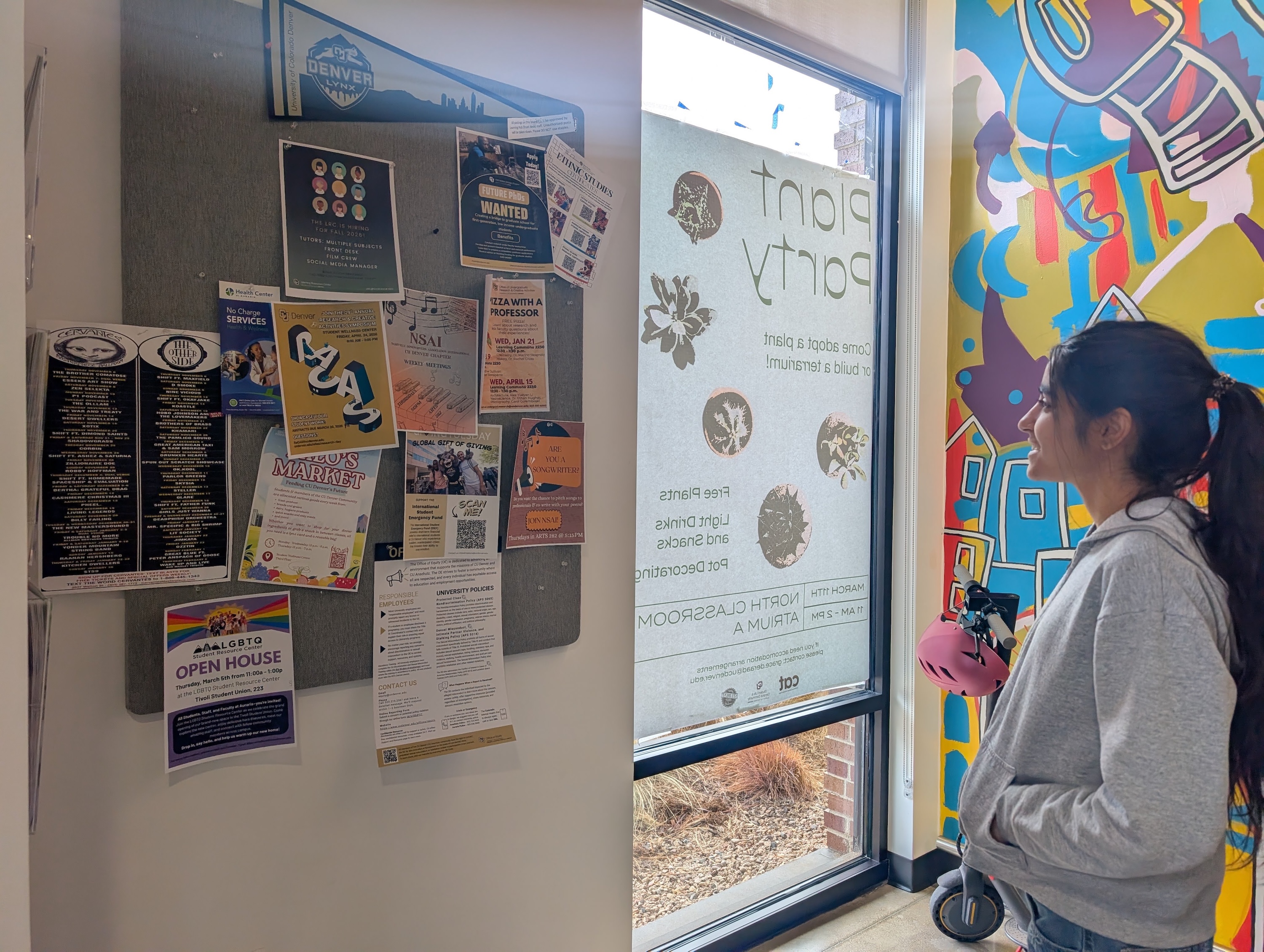 Smiling person looking at a display of flyers
