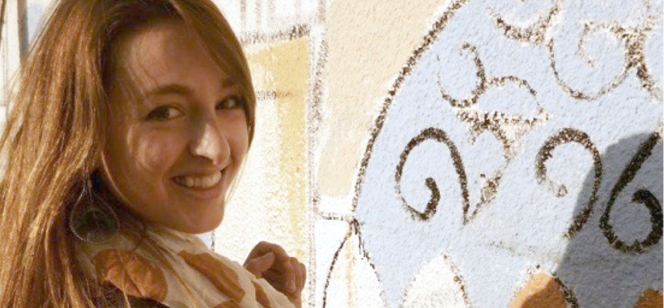 Marissa Bennett painting on a wall