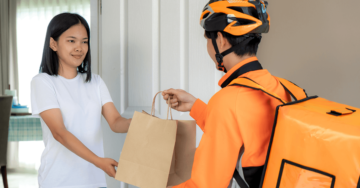 A woman receiving a food delivery.