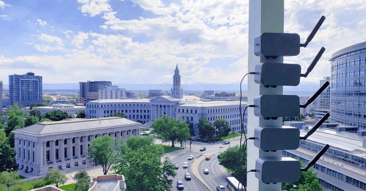 Five monitors lining a pole overlooking the state capitol building.