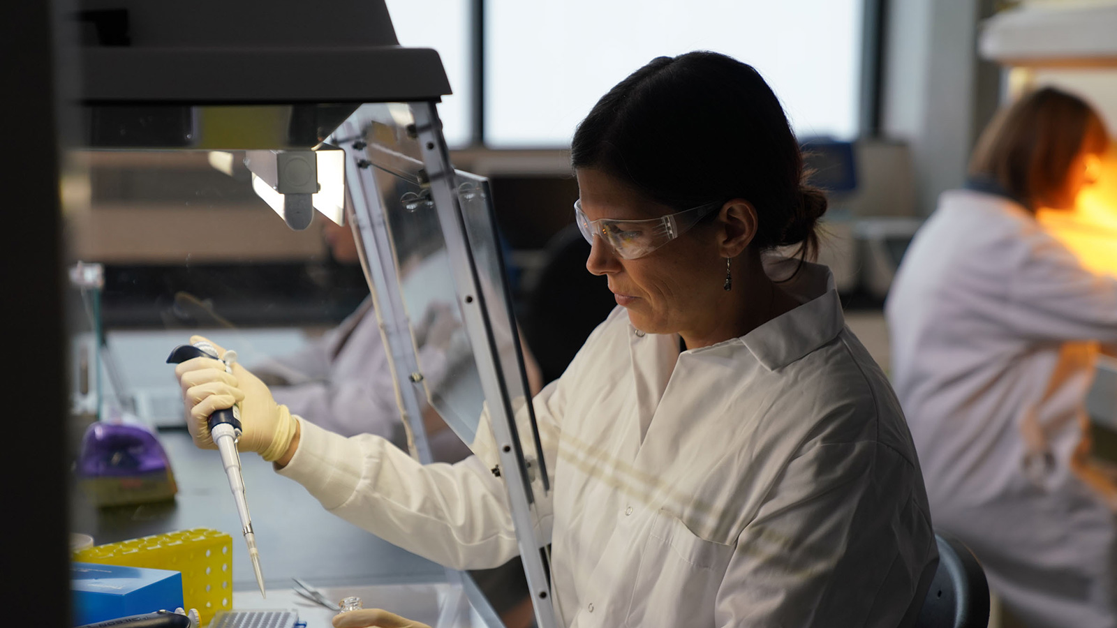 Researcher working in a lab with pipette