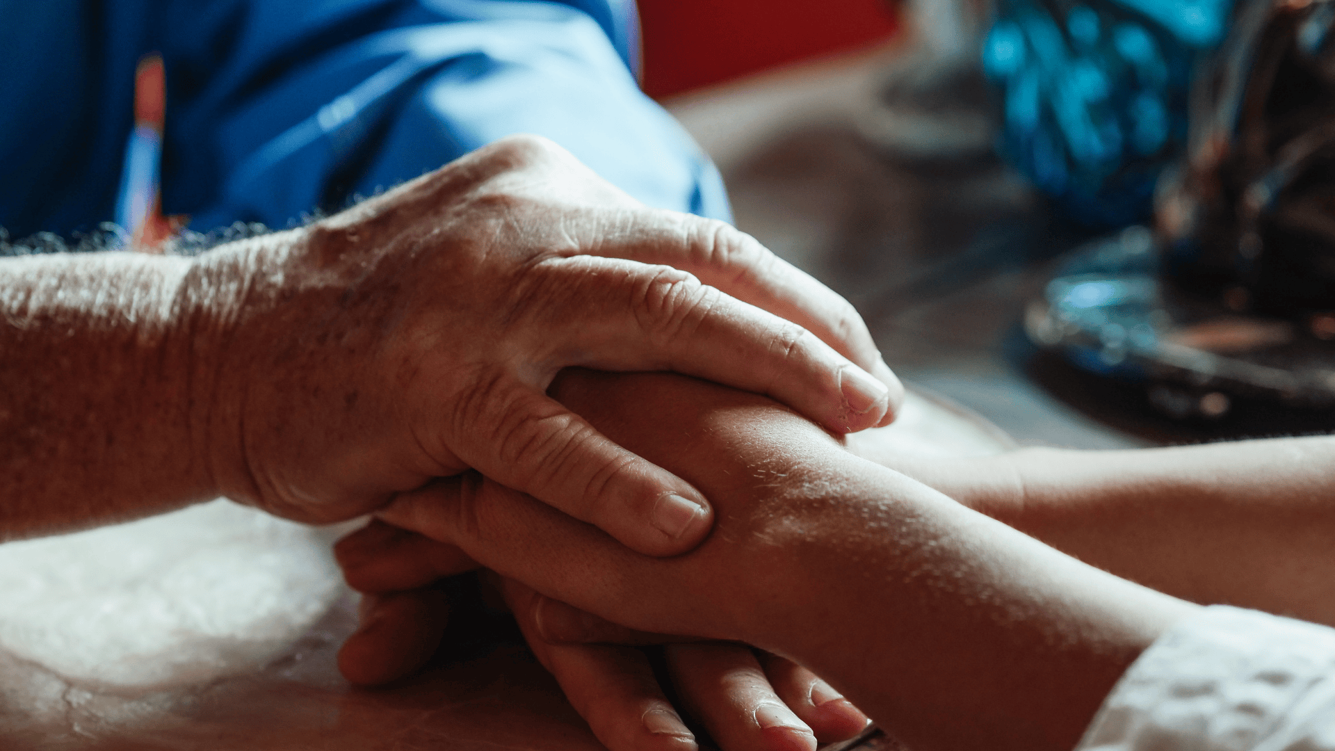 Close up of an older man clasping hand with a younger person
