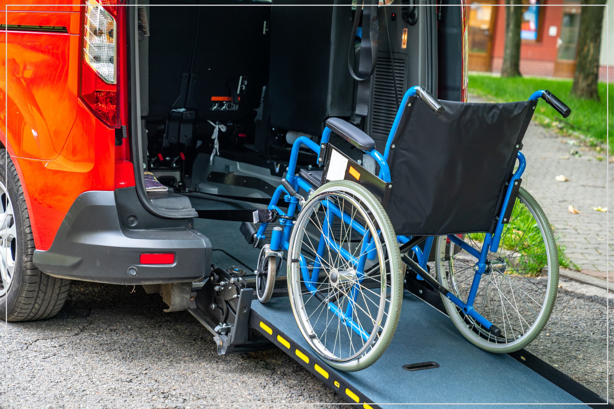 A wheelchair sits on the ramp into a van