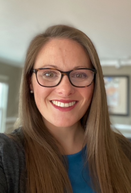 Headshot of a women. Background is blurred