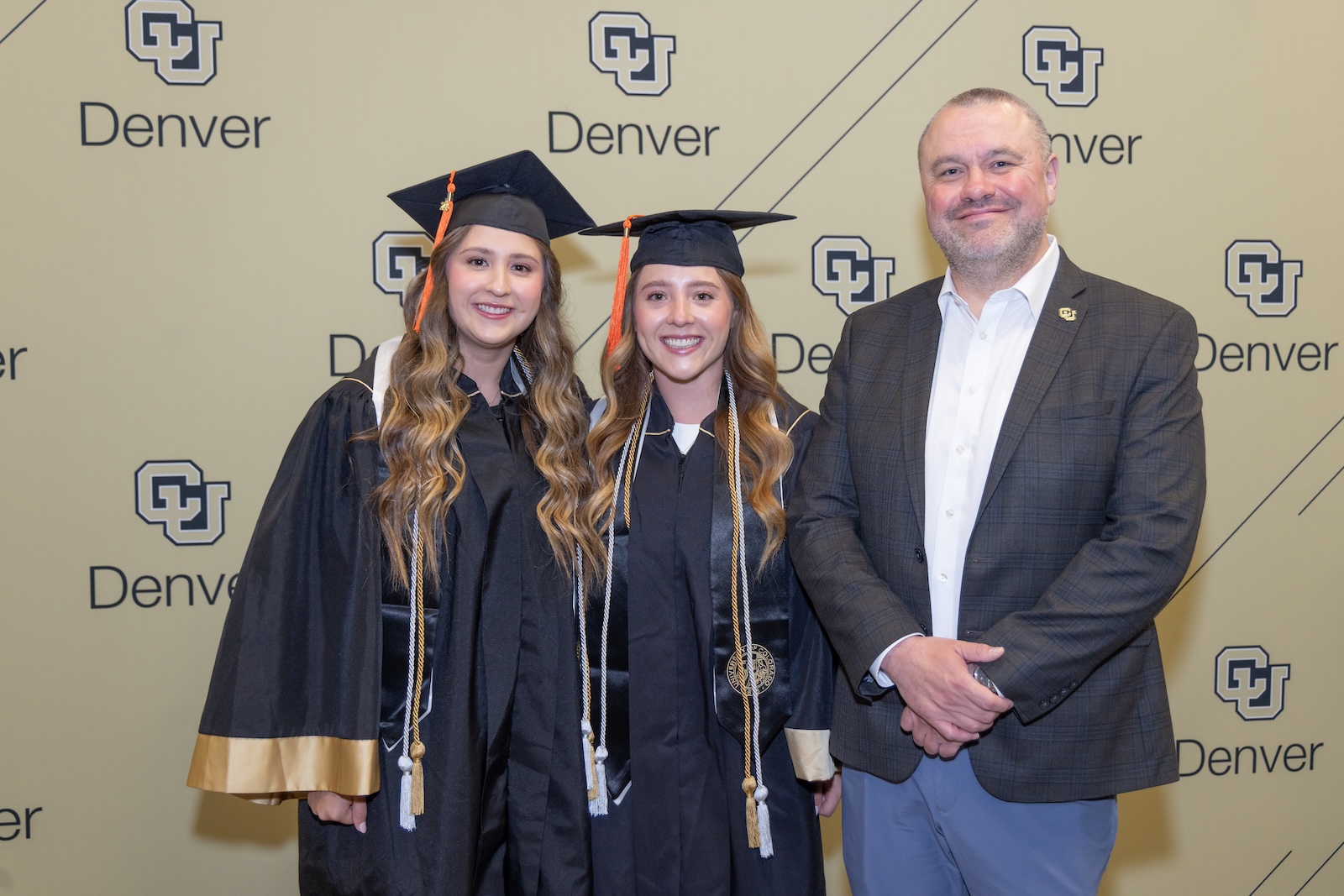 Chancellor Christensen with Ashlynn and Deveyn Hainey at Commencement